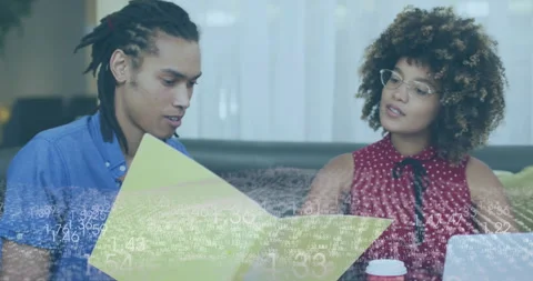 Discussing documents, two people with data processing animation overlay in Stock Footage 305031669