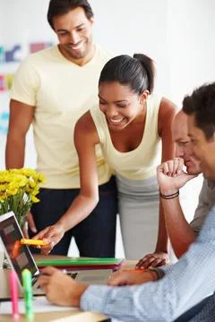 Discussing elements of design. a diverse group of coworkers discussing a project Stock Photos