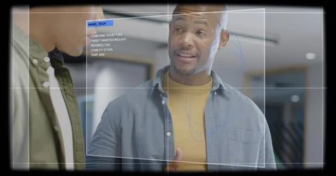 Discussing engineer wearing blue shirt and mustard knit gesturing in lab, with Stock Photos