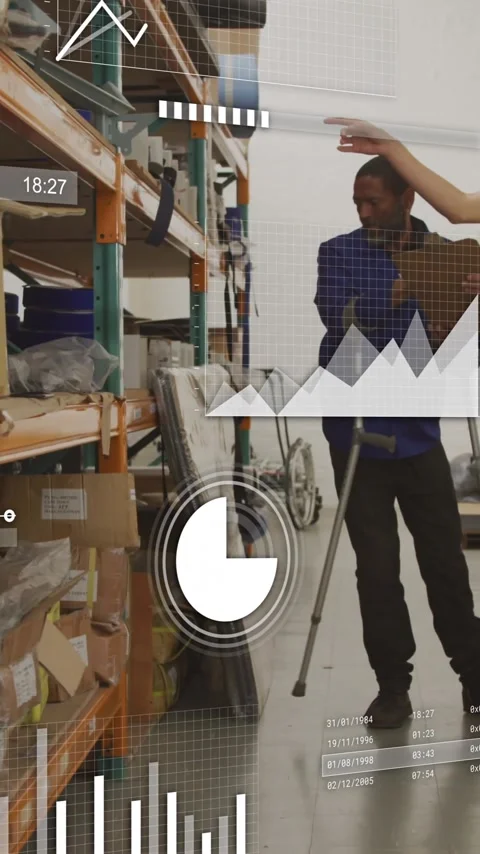 Discussing inventory, warehouse workers using data analytics overlay for Stock Footage 319810959