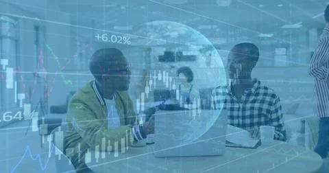 Discussing pair wearing yellow jacket at round table in office with laptop and Stock Photos