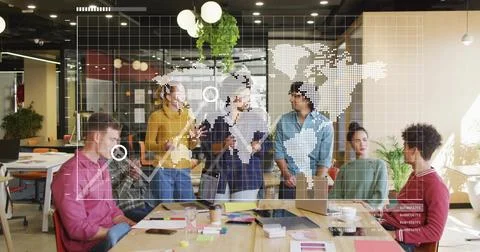 Discussing plan, team in sweaters pointing at laptops around wood table in Stock Photos