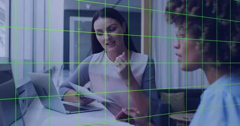 Discussing printed documents, two colleagues gesturing and listening in meeting Stock Photos
