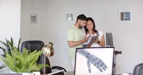 Discussing project, colleagues using tablet and computer in modern office Stock Footage 299678279