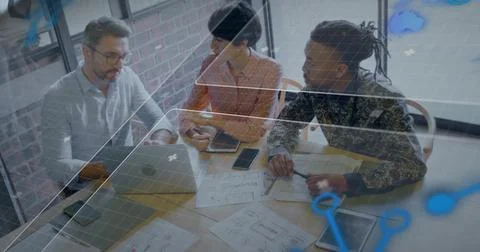 Discussing team leaning over table in office reviewing MacBook sketches, woman Foto stock