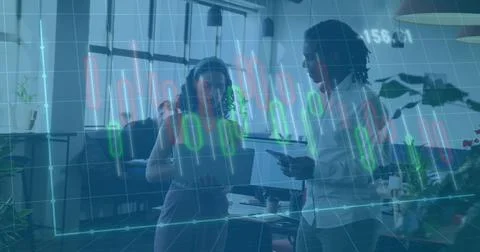 Discussing two colleagues analyzing translucent financial charts in office wi Stock Photos