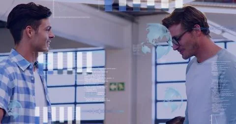 Discussing two coworkers comparing data overlays in studio, wearing casual Stock Photos