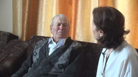Discussion between old man patient and doctor, home view, suffering, disease Stock Footage 45384075