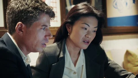 Discussion between two professionals in a modern workspace during a meeting Stock-Footage 304539165