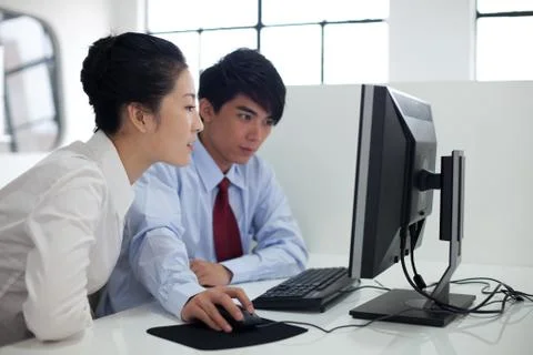 Discussion in front of the computer Stock Photos