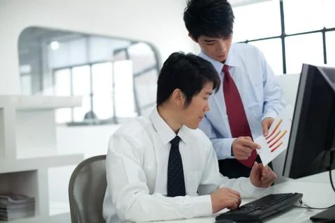 Discussion in front of the computer Stock Photos