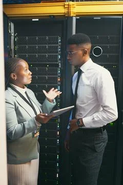Discussion, manager or engineer with tablet in server room, upgrade or explain Stock Photos