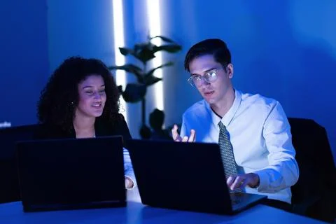 Discussion on a project between two colleagues in a modern office setting w.. Stock Photos
