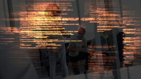Discussion starting, orange code overlay appearing, team clustering around Stock Footage 333131914