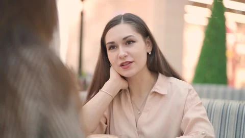Discussion two women. chat while sitting in cafeteria in shopping center Stock Footage 144598913