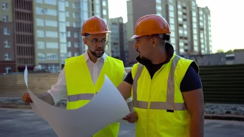 Discussion of two young workers in helmets Video stock 157714178