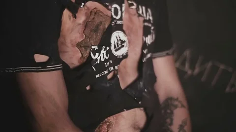 The disfigured exhausted guy tries to escape from the maniac Stock Footage 76607399