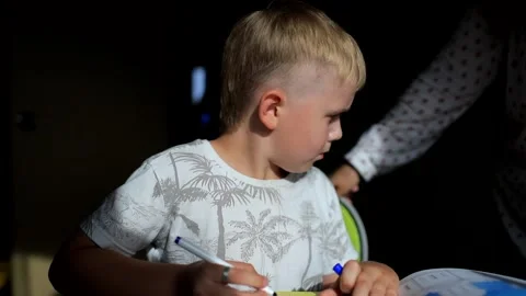 Disgruntled boy does lessons, and mom checks Stock Footage 130909784
