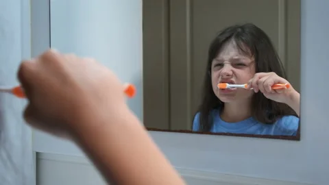Disgruntled child brushes his teeth. Stock Footage 233120923