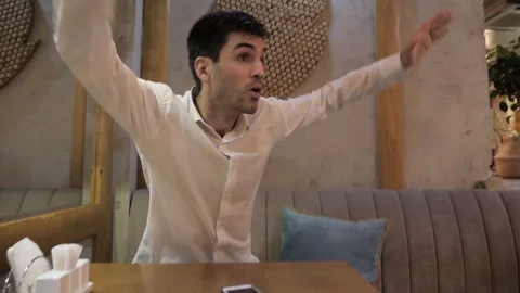 Disgruntled guest waves hands and asks to take order in cafe Stock Footage 106328149