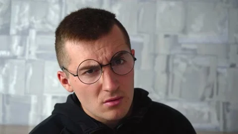 Disgruntled man looks at the camera Stock Footage 140284752