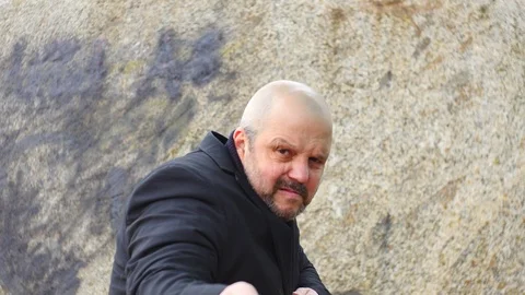 Disgruntled modern man in suit pulling rope front view Stock Footage 104565044