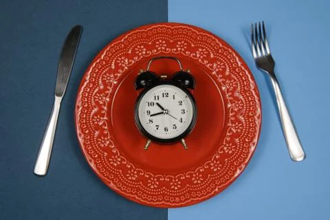 Dish with alarm clock inside Stock Photos