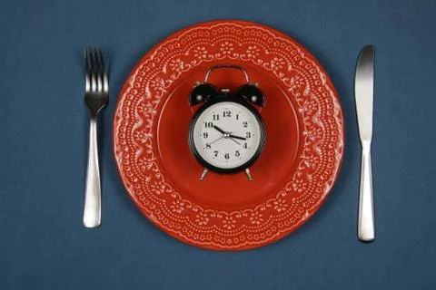 Dish with alarm clock inside Stock Photos