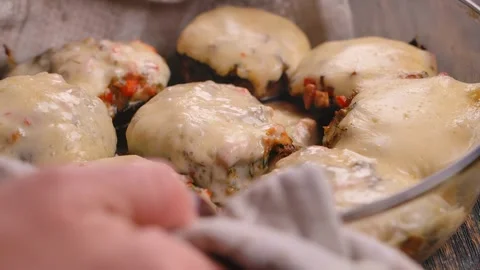 A dish of baked stuffed champignons is placed on the table Stock Footage 296582028