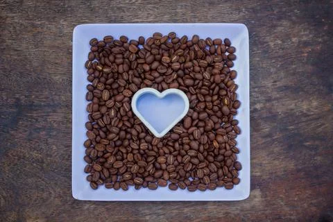 Dish with coffee beans Stock Photos