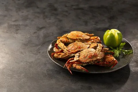 Dish of cooked crabs on the table. Stock Photos