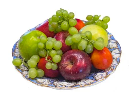 Dish decorated with blue-aureate patterns with fruits, isolated on white back Stock Photos