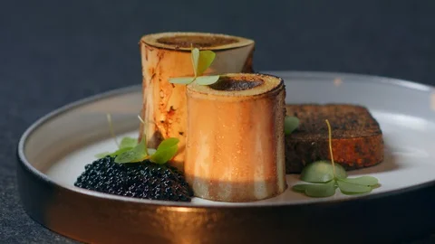 Dish exclusive boar bone marrow luxury black caviar and shamrock Stock Footage 129569952