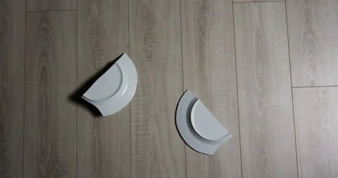 Dish falling to the floor and shattering, slow motion medium shot Stock Footage 152581196