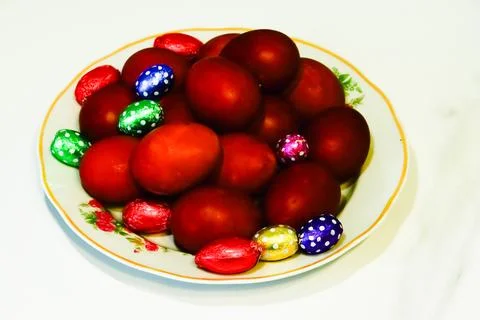 A dish filled with brightly colored eggs Stock Photos