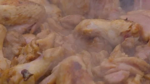 A dish on a fire in a cauldron. The meat is stewed in a cauldron. Chicken meat Stock Footage 279271705