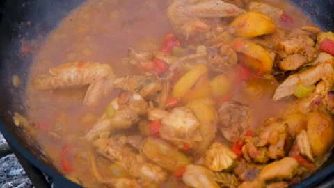A dish on a fire in a cauldron. Stewing meat in a cauldron. The meat is stewed Stock Footage 279271568