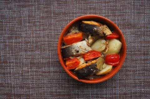 A dish of fish with vegetables. Stock Photos
