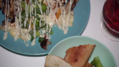 Dish with fried eggs, greens and sauce on plate with drink. Vidéo 333862936