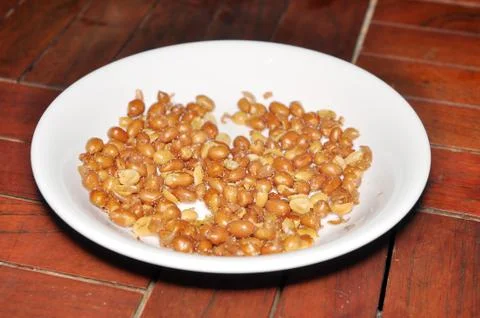 Dish of fried peanuts Stock Photos