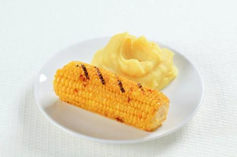 Dish of grilled  sweet corn with mashed potato Stock Photos