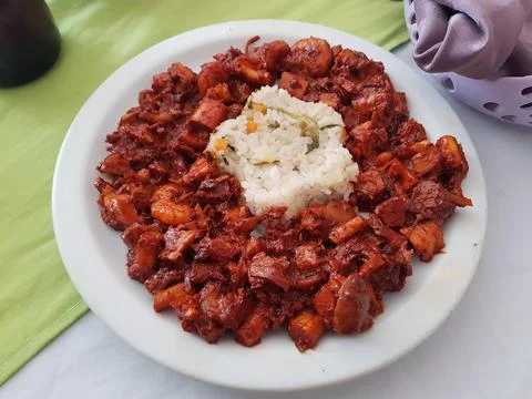Dish made of a combination of shellfish, snail and shrimp accompanied by rice Stock Photos