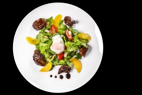 Dish of meat, lettuce, oranges, nuts and chicken egg Stock Photos