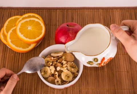 Dish with muesli which poured milk Stock Photos