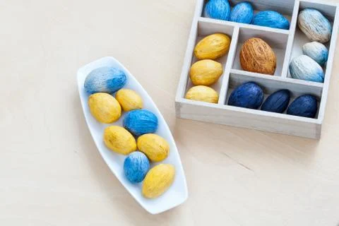 Dish with nuts next to the box full of nuts Stock Photos