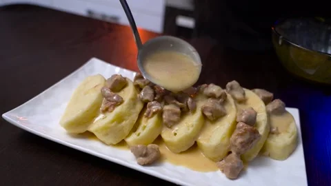 The dish is poured with gravy from the meat Stock Footage 171666038
