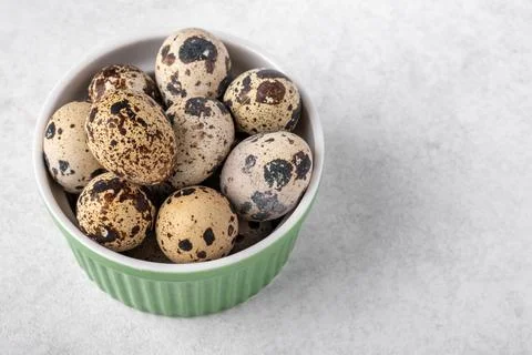 A dish with quail eggs placed on a textured surface. Concept of healthy eating Stock Photos