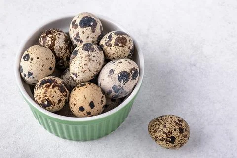 A dish with quail eggs placed on a textured surface. Concept of healthy eating Stock Photos