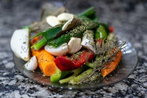 Dish with raw chopped vegetables on a granite countertops Stock Photos
