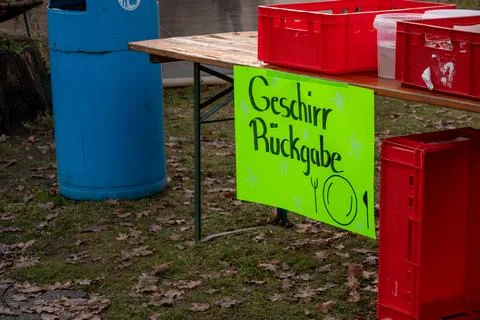 Dish return sign on table with plastic crates Photos